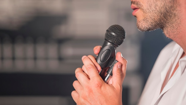 Sideways man singing at microphone