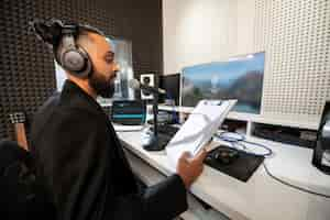 Free photo sideways man working at a radio station