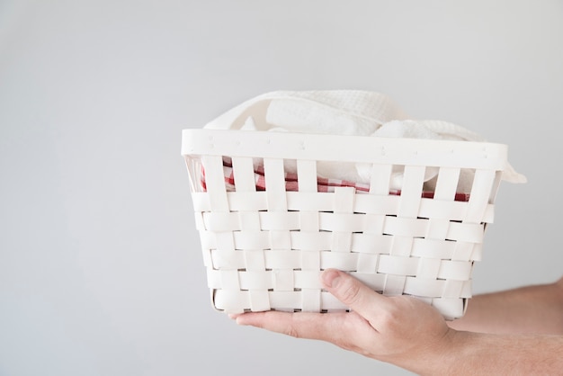 Free photo sideways person holding laundry basket