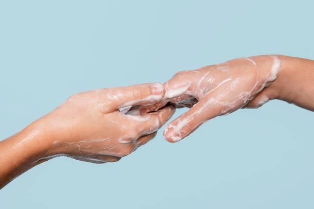 Free photo sideways person washing hands isolated on blue