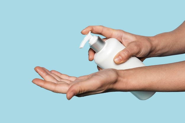 sideways person washing hands isolated on blue