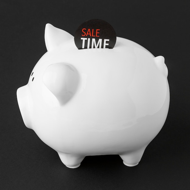 Free photo sideways piggy bank with sale label