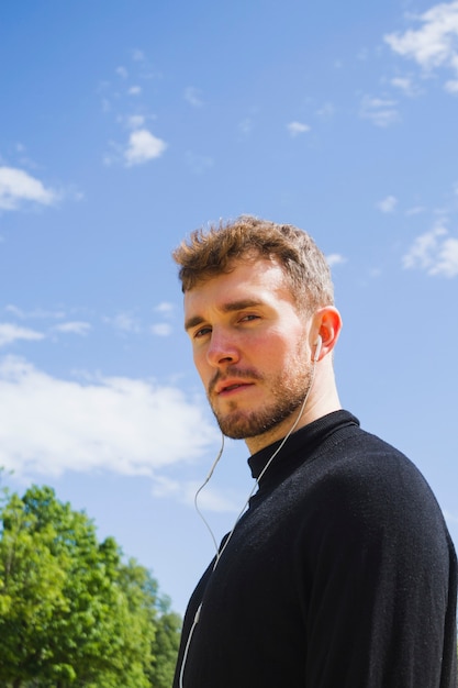 Sideways portrait of a man looking at camera