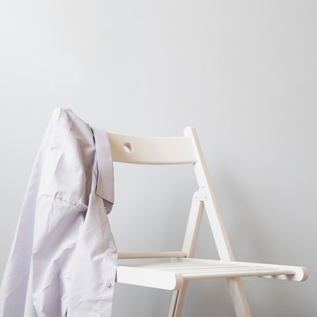 Free photo sideways shirt on a white chair