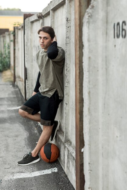 Sideways urban basketball player posing