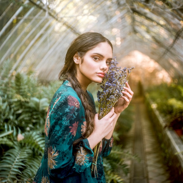 Sideways woman holding lavender flowers