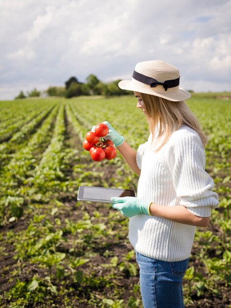 Sideways woman holding some tomatoes