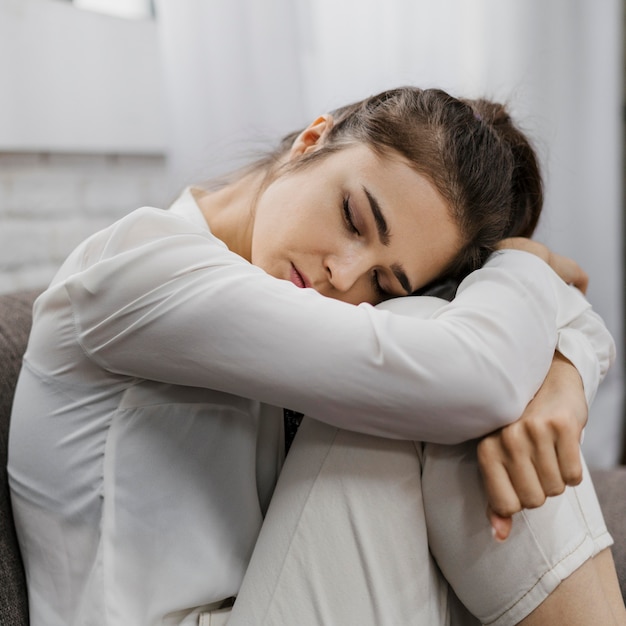 Free photo sideways woman looking sad as she works from home