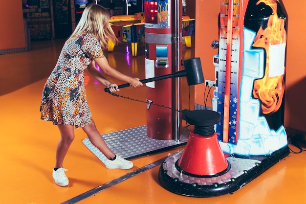 Free photo sideways woman playing arcade game