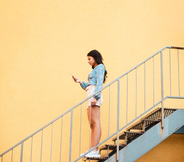 Sideways woman standing on stairs