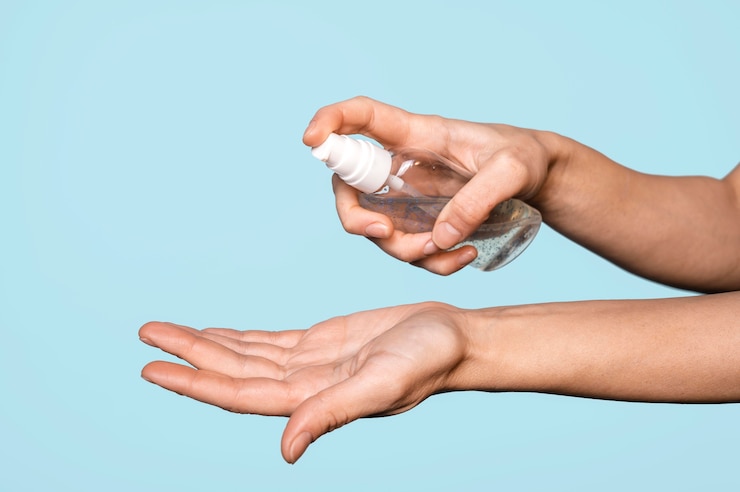 Free Photo sideways woman washing hands isolated on blue