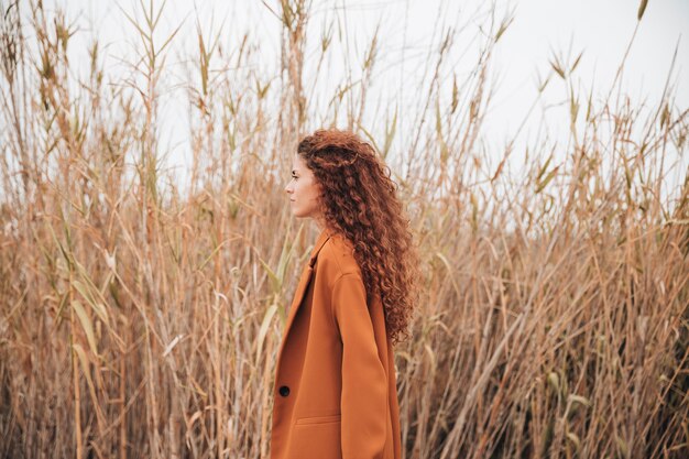 Sideways woman in wheat field looking away