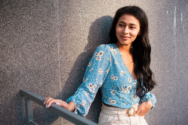 Sideways woman in white pants and floral shirt