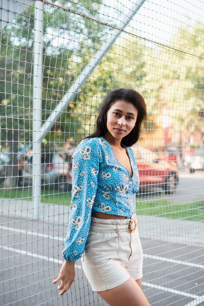 Sideways woman in white pants and floral shirt