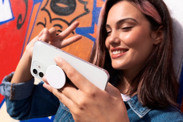 sied view woman holding smartphone