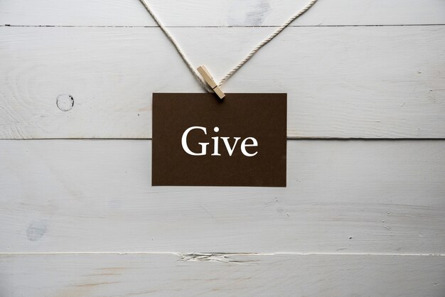 Sign attached to a rope with GIVE written on it