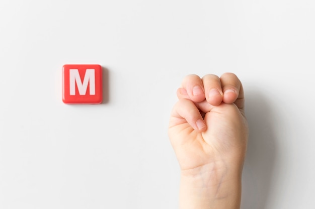 Sign language hand showing letter m