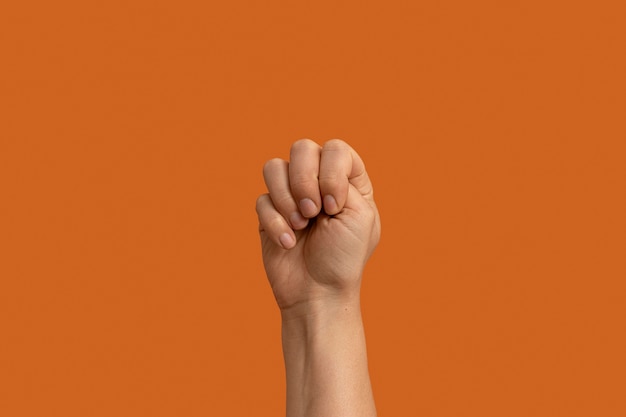 Free photo sign language symbol isolated on orange