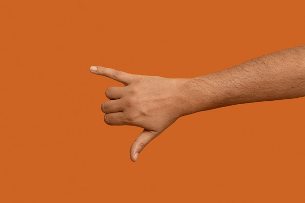 Free photo sign language symbol isolated on orange