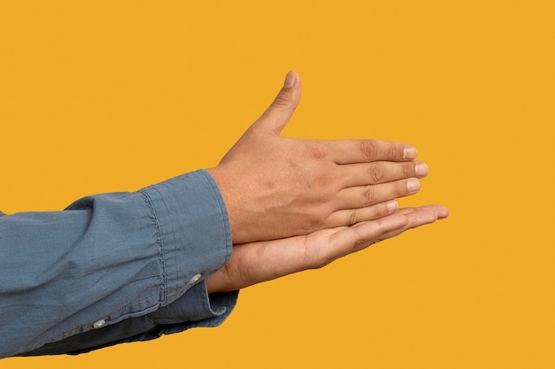 Free photo sign language symbol isolated on yellow