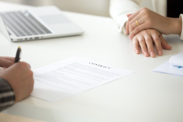 Signing business contract concept, man putting signature on legal document