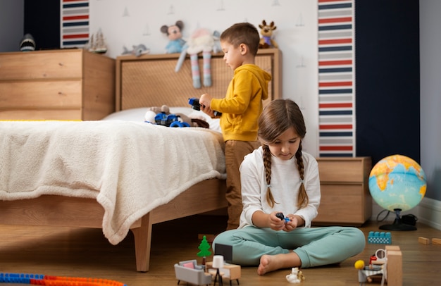 Silbiling playing together in their room