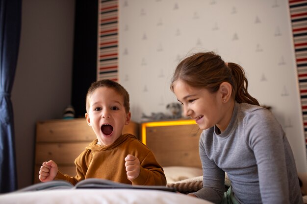 Silbiling playing together in their room