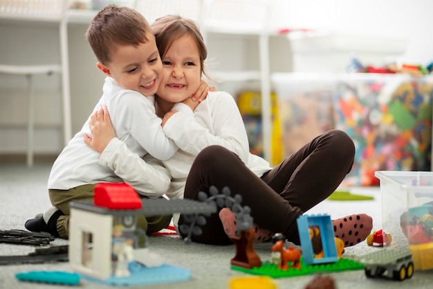 Silbiling playing together in their room