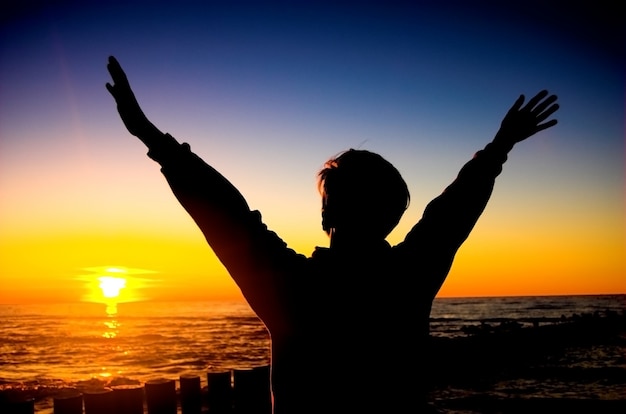 Free photo silhouette of aman with raised arms