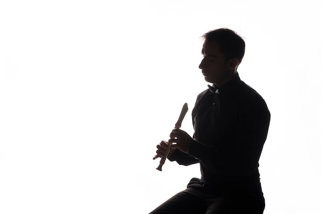 Silhouette of an artist playing the flute