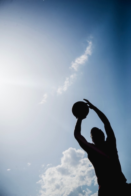 Silhouette of basketball player about to throw