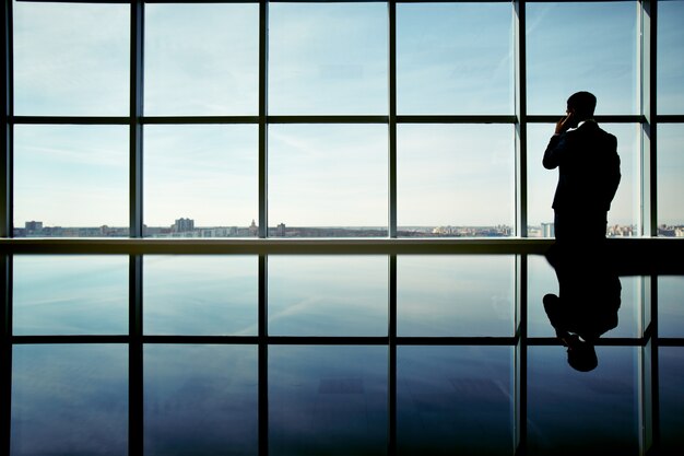 Silhouette of businessman enjoying the view