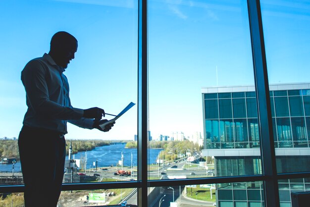 Silhouette of businessman holding a document