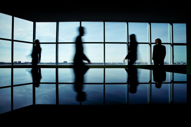 Silhouette of businesspeople rushing to work