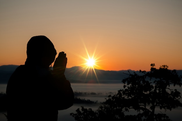 Free photo silhouette of christian man praying