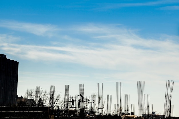 Silhouette of construction workers on the yard