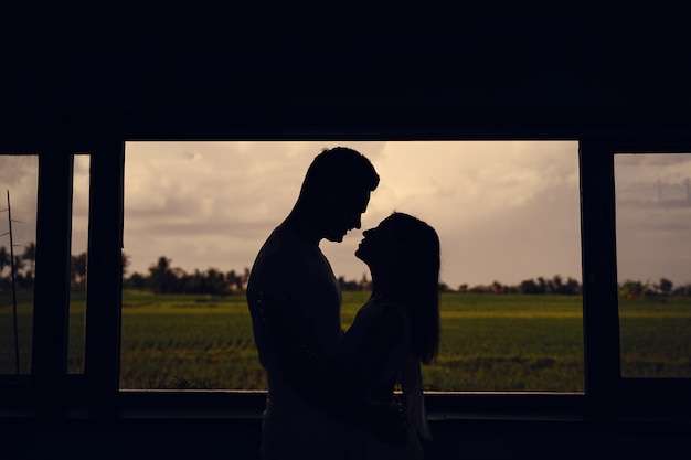 Silhouette of couple on sunset background