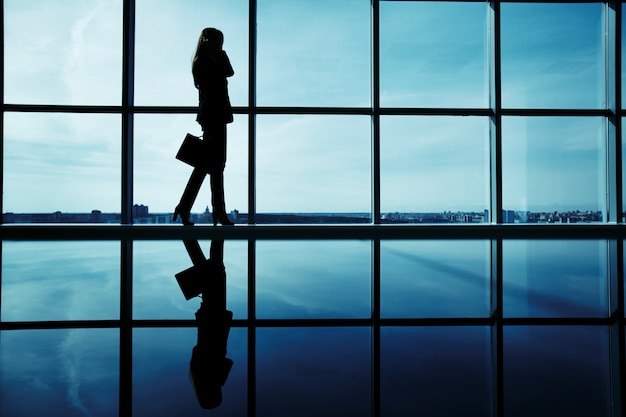 Silhouette of female executive with briefcase