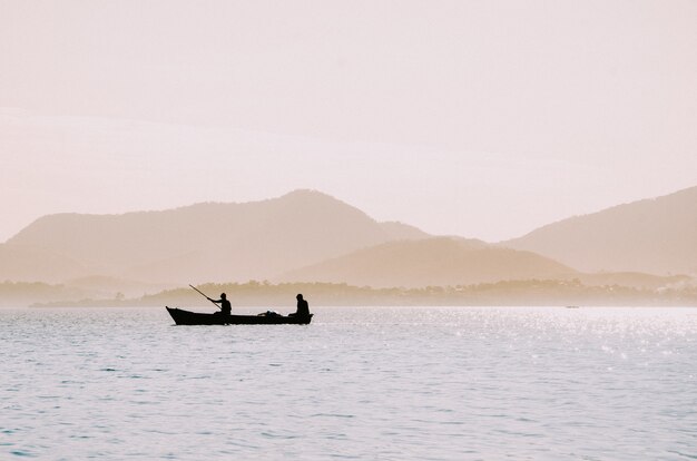 Silhouette of fishermen in a small boat