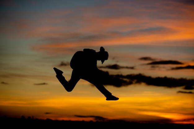 Silhouette girl guitarist on a sunset