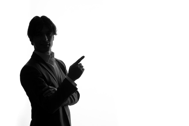 Silhouette of man in strict suit in business pose shadow back lit white background