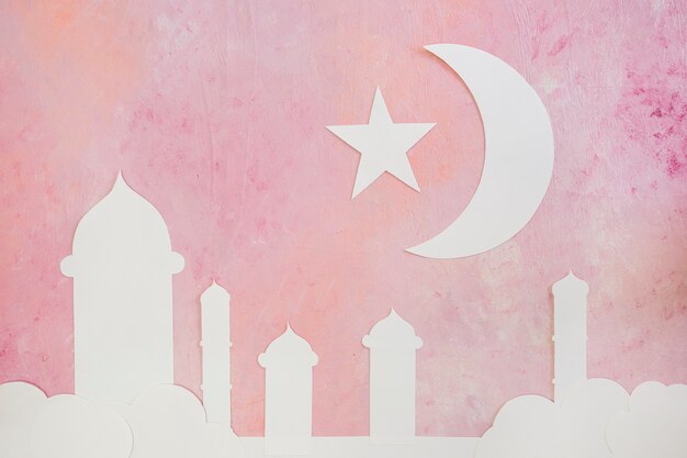 Silhouette of mosque towers and crescent on pink