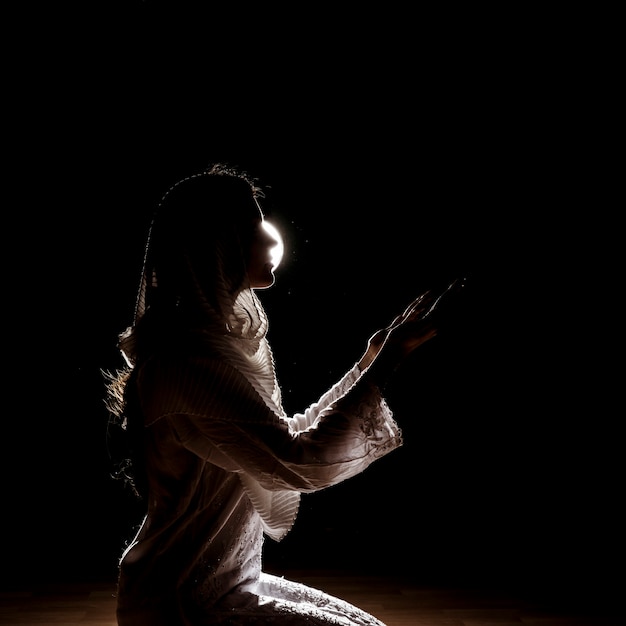 Free photo silhouette of muslim woman praying