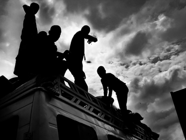 Silhouette of people on a car