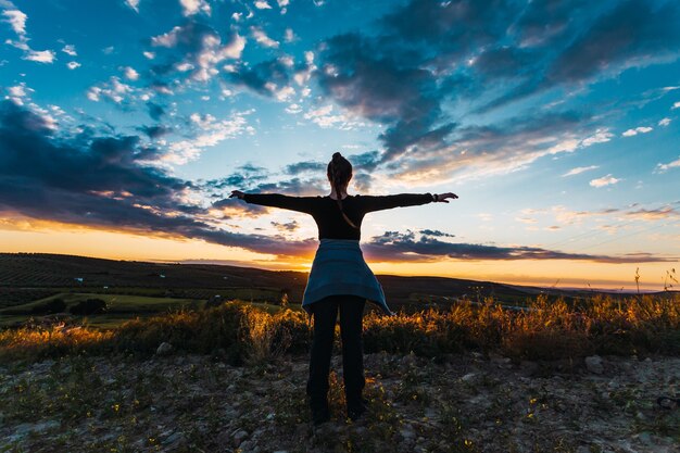 Silhouette shot of a young female hiker in the countryside in Spain