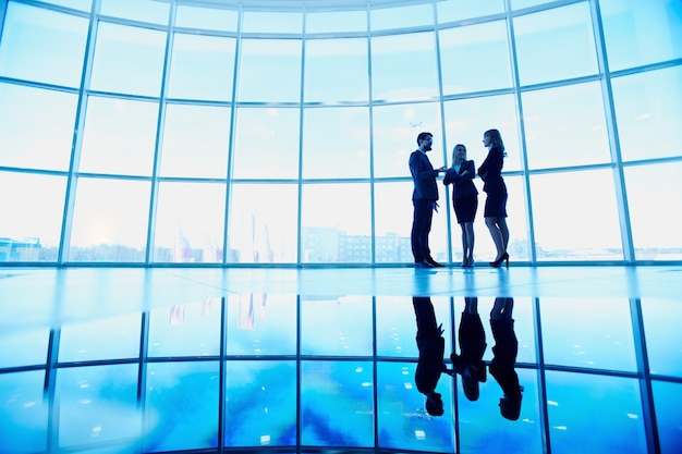 Silhouette of three executives in the office