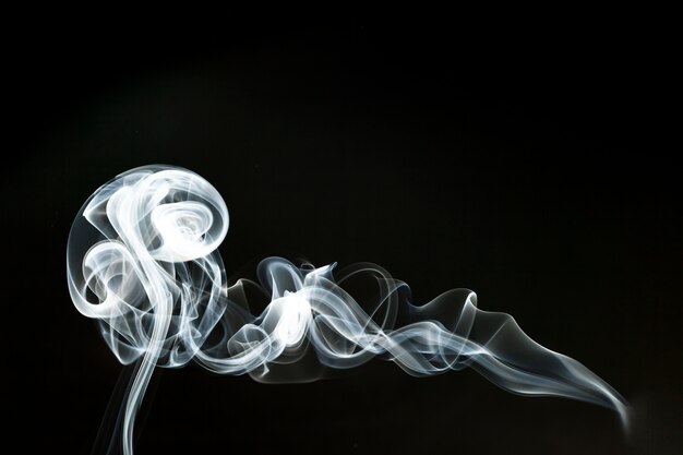 Silhouette of white wavy smoke