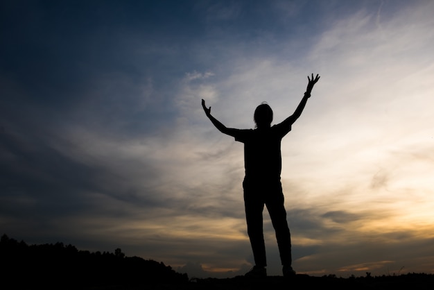 Free photo silhouette of woman praying with god