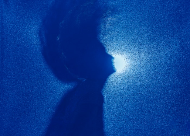 Silhouette of woman shaking hair