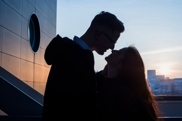 Silhouette of a young couple loving each other at outdoors